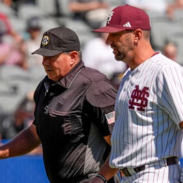 Mississippi State interim head coach Justin Parker discusses things with home plate umpire David Savage during the game with Texas A&M in the first round of the SEC Baseball Tournament at the Hoover Met.