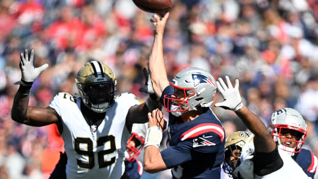 New England Patriots quarterback Mac Jones (10) under pressure from New Orleans Saints defensive end Tanoh Kpassagnon (92)