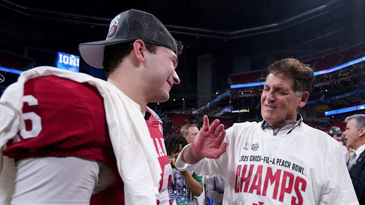 Mark Cuban talks with Indiana Hoosiers quarterback Alberto Mendoza (16) on Friday, Jan. 9, 2026, after the Indiana Hoosiers defeated the Oregon Ducks in the Peach Bowl and semifinal game of the College Football Playoff at Mercedes-Benz Stadium in Atlanta.