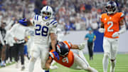 Denver Broncos safety Talanoa Hufanga (9) pushes Indianapolis Colts running back Jonathan Taylor (28) out of bounds Sunday, Sept. 14, 2025, during a game at Lucas Oil Stadium in Indianapolis.