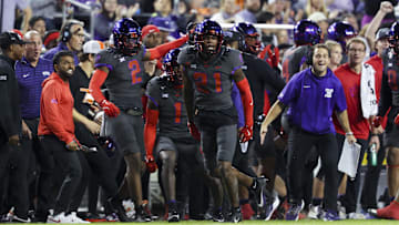 Nov 9, 2024; Fort Worth, Texas, USA;  TCU Horned Frogs safety Bud Clark (21) reacts after making an interception during the first half against the Oklahoma State Cowboys at Amon G. Carter Stadium. Mandatory Credit: Kevin Jairaj-Imagn Images