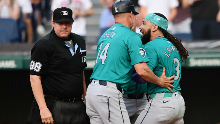 Jun 19, 2024; Cleveland, Ohio, USA; Seattle Mariners shortstop J.P. Crawford (3) is restrained by third base coach Manny Acta (14) and manager Scott Servais (9) while arguing with umpire Doug Eddings (88) after a strike out during the fifth inning against the Cleveland Guardians at Progressive Field. Mandatory Credit: Ken Blaze-USA TODAY Sports
