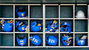 Jun 14, 2025; Omaha, Neb, USA; Helmets sit in the UCLA Bruins dugout before the game against the Murray State Racers at Charles Schwab Field. Mandatory Credit: Dylan Widger-Imagn Images