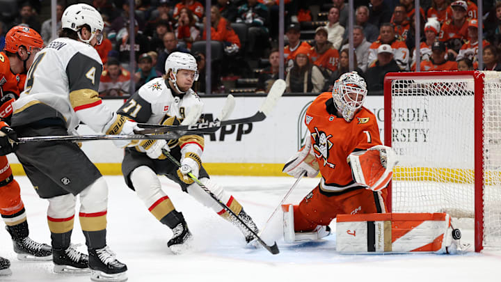 May 14, 2026; Anaheim, California, USA; Anaheim Ducks goaltender Lukas Dostal (1) makes a save as Vegas Golden Knights defenseman Rasmus Andersson (4) and center William Karlsson (71) look on during the first period in game six of the second round of the 2026 Stanley Cup Playoffs at Honda Center. Mandatory Credit: Kiyoshi Mio-Imagn Images