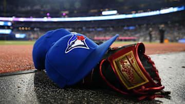May 10, 2024; Toronto, Ontario, CAN; A pair of Toronto Blue Jays hats and glove in the dugout during a game against the Minnesota Twins at Rogers Centre.