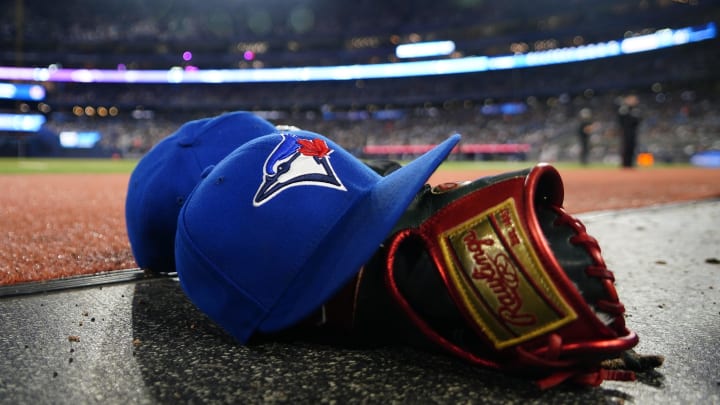 May 10, 2024; Toronto, Ontario, CAN; A pair of Toronto Blue Jays hats and glove in the dugout during a game against the Minnesota Twins at Rogers Centre. Mandatory Credit: John E. Sokolowski-USA TODAY Sports