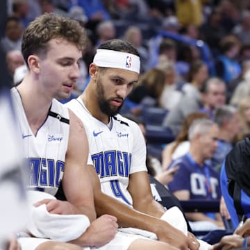 Orlando Magic guard Jalen Suggs (4) and forward Franz Wagner (22) listen to head coach Jamahl Mosley during a time out against the Oklahoma City Thunder in the second half at Paycom Center. 