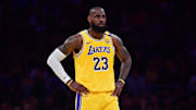 LeBron James puts his hands on his hips during a Lakers game.