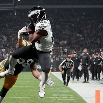 Sep 6, 2024; Sao Paulo, BRA; Philadelphia Eagles running back Saquon Barkley (26) catches a touchdown against Green Bay Packers linebacker Isaiah McDuffie (58) and safety Xavier McKinney (29) during the second quarter at Neo Quimica Arena. Mandatory Credit: Kirby Lee-Imagn Images