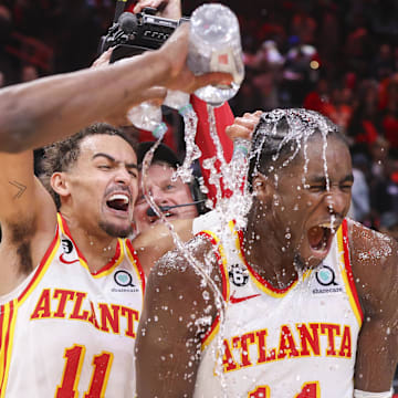 Nov 19, 2022; Atlanta, Georgia, USA; Atlanta Hawks guard Trae Young (11) dumps water on forward AJ Griffin (14) after an overtime victory against the Toronto Raptors at State Farm Arena. Mandatory Credit: Brett Davis-Imagn Images
