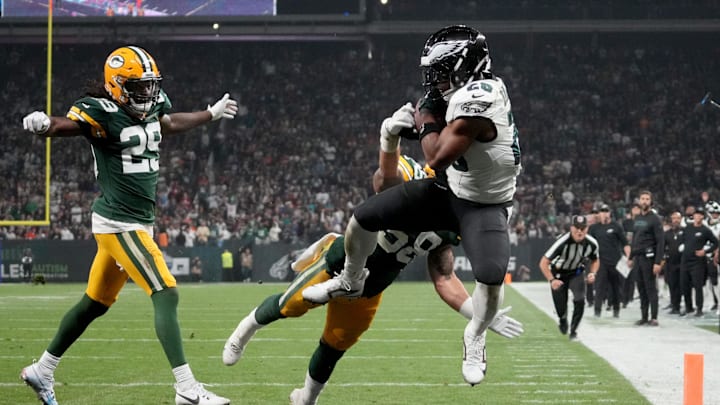 Sep 6, 2024; Sao Paulo, BRA; Philadelphia Eagles running back Saquon Barkley (26) catches a touchdown against Green Bay Packers linebacker Isaiah McDuffie (58) and safety Xavier McKinney (29) during the second quarter at Neo Quimica Arena. Mandatory Credit: Kirby Lee-Imagn Images