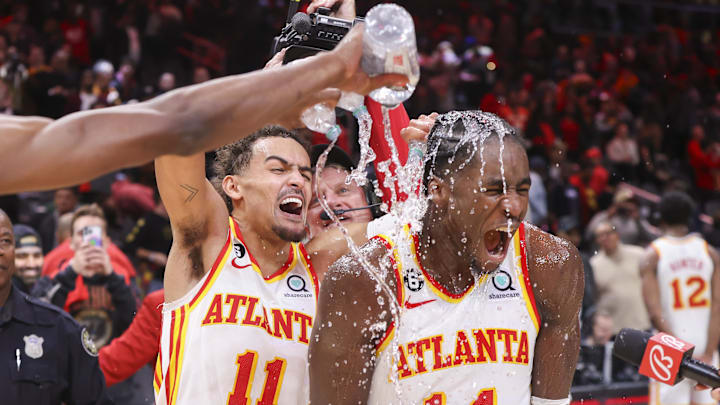 Nov 19, 2022; Atlanta, Georgia, USA; Atlanta Hawks guard Trae Young (11) dumps water on forward AJ Griffin (14) after an overtime victory against the Toronto Raptors at State Farm Arena. Mandatory Credit: Brett Davis-Imagn Images
