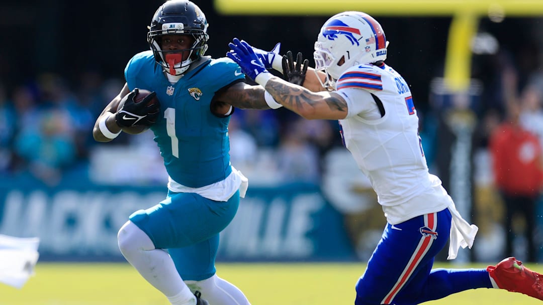 Jacksonville Jaguars running back Travis Etienne Jr. rushes for yards against Buffalo Bills cornerback Taron Johnson.