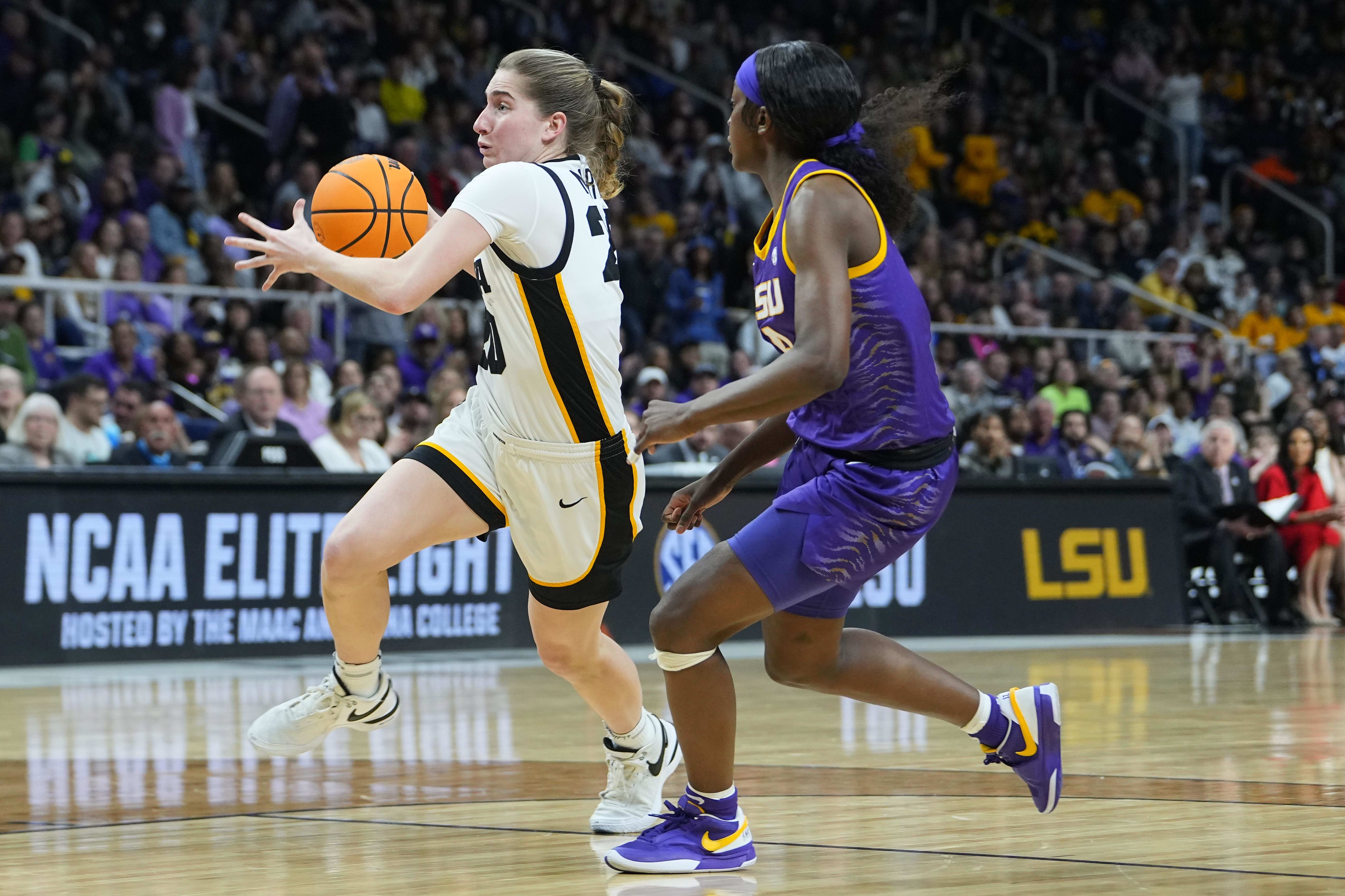 LSU Tigers guard Flau'Jae Johnson defends Iowa Hawkeyes guard Kate Martin.