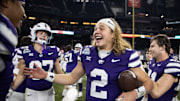 Dec 26, 2024; Phoenix, AZ, USA; Kansas State Wildcats quarterback Avery Johnson (2) celebrates after defeating the Rutgers Scarlet Knights during the Rate Bowl at Chase Field. Mandatory Credit: Mark J. Rebilas-Imagn Images