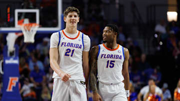 Dec 29, 2024; Gainesville, Florida, USA; Florida Gators forward Alex Condon (21) and Florida Gators guard Alijah Martin (15) smile while walking to position against the Stetson Hatters during the second half at Exactech Arena at the Stephen C. O'Connell Center. Mandatory Credit: Matt Pendleton-Imagn Images