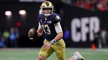 Notre Dame Fighting Irish quarterback Riley Leonard (13) looks to pass the ball against the Ohio State Buckeyes during the first half the CFP National Championship college football game at Mercedes-Benz Stadium.