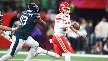 Feb 9, 2025; New Orleans, LA, USA; Kansas City Chiefs quarterback Patrick Mahomes (15) runs away from Philadelphia Eagles defensive tackle Milton Williams (93) in the third quarter in Super Bowl LIX at Ceasars Superdome. Mandatory Credit: Mark J. Rebilas-Imagn Images