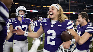 Dec 26, 2024; Phoenix, AZ, USA; Kansas State Wildcats quarterback Avery Johnson (2) celebrates after defeating the Rutgers Scarlet Knights during the Rate Bowl at Chase Field. Mandatory Credit: Mark J. Rebilas-Imagn Images