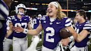 Dec 26, 2024; Phoenix, AZ, USA; Kansas State Wildcats quarterback Avery Johnson (2) celebrates after defeating the Rutgers Scarlet Knights during the Rate Bowl at Chase Field. Mandatory Credit: Mark J. Rebilas-Imagn Images