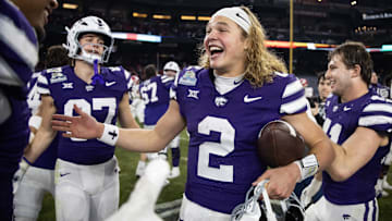 Dec 26, 2024; Phoenix, AZ, USA; Kansas State Wildcats quarterback Avery Johnson (2) celebrates after defeating the Rutgers Scarlet Knights during the Rate Bowl at Chase Field. Mandatory Credit: Mark J. Rebilas-Imagn Images
