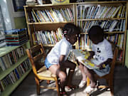Young Students Reading in One-Room Schoolhouse