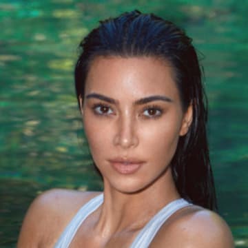 Kim Kardashian was photographed by Greg Swales in the Dominican Republic. Swimsuit by SKIMS. 