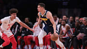 Mar 19, 2023; Brooklyn, New York, USA; Denver Nuggets forward Michael Porter Jr. (1) dribbles against Brooklyn Nets forward Cameron Johnson (2) during the second half at Barclays Center. Mandatory Credit: Vincent Carchietta-Imagn Images