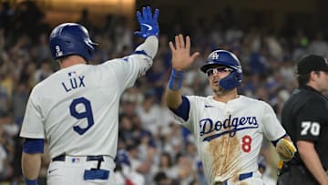 Aug 28, 2024; Los Angeles, California, USA;  Los Angeles Dodgers first baseman Enrique Hernandez (8) is met by second baseman Gavin Lux (9) after scoring a run against the Baltimore Orioles at Dodger Stadium. Mandatory Credit: Jayne Kamin-Oncea-Imagn Images