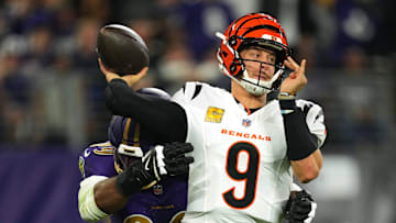 Nov 7, 2024; Baltimore, Maryland, USA; Cincinnati Bengals quarterback Joe Burrow (9) is pressured by Baltimore Ravens linebacker Odafe Oweh (99) during the first quarter at M&T Bank Stadium. Mandatory Credit: Mitch Stringer-Imagn Images