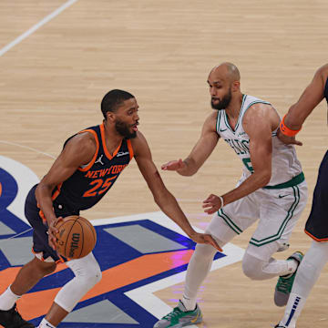 May 12, 2025; New York, New York, USA; New York Knicks forward Mikal Bridges (25) dribbles as Boston Celtics guard Derrick White (9) fights through a screen by New York Knicks center Karl-Anthony Towns (32) in the first half during game four of the second round for the 2025 NBA Playoffs at Madison Square Garden. Mandatory Credit: Vincent Carchietta-Imagn Images