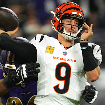 Nov 7, 2024; Baltimore, Maryland, USA; Cincinnati Bengals quarterback Joe Burrow (9) is pressured by Baltimore Ravens linebacker Odafe Oweh (99) during the first quarter at M&T Bank Stadium. Mandatory Credit: Mitch Stringer-Imagn Images