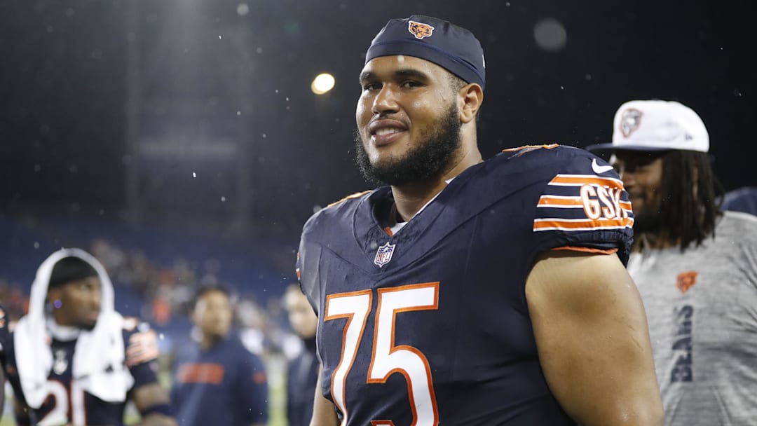 Aug 1, 2024; Canton, Ohio, USA;  Chicago Bears offensive tackle Larry Borom (75) joins teammates in exiting the field due to lightning during the third quarter against the Houston Texans at Tom Benson Hall of Fame Stadium. Mandatory Credit: Charles LeClaire-Imagn Images