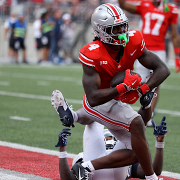 Aug 31, 2024; Columbus, Ohio, USA;  Ohio State Buckeyes wide receiver Jeremiah Smith (4) makes a long catch against the Akron Zips during the second half at Ohio Stadium. Mandatory Credit: Joseph Maiorana-Imagn Images