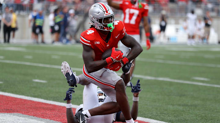 Aug 31, 2024; Columbus, Ohio, USA;  Ohio State Buckeyes wide receiver Jeremiah Smith (4) makes a long catch against the Akron Zips during the second half at Ohio Stadium. Mandatory Credit: Joseph Maiorana-Imagn Images