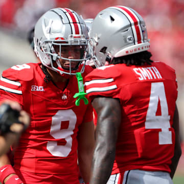 Aug 31, 2024; Columbus, Ohio, USA;  Ohio State Buckeyes wide receiver Jeremiah Smith (4) celebrates with wide receiver Jayden Ballard (9) after scoring a touchdown against the Akron Zips during the first quarter at Ohio Stadium. Mandatory Credit: Joseph Maiorana-Imagn Images