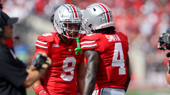 Aug 31, 2024; Columbus, Ohio, USA;  Ohio State Buckeyes wide receiver Jeremiah Smith (4) celebrates with wide receiver Jayden Ballard (9) after scoring a touchdown against the Akron Zips during the first quarter at Ohio Stadium. Mandatory Credit: Joseph Maiorana-Imagn Images