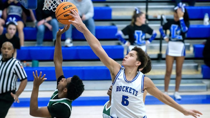Limestone’s Kavion Graham (5) gets a hand on a shot by Richwoods’ Marlon Herron Jr. in the second half of their high school basketball game Friday, Jan. 10, 2025 in Bartonville. The Knights defeated the Rockets 50-45.