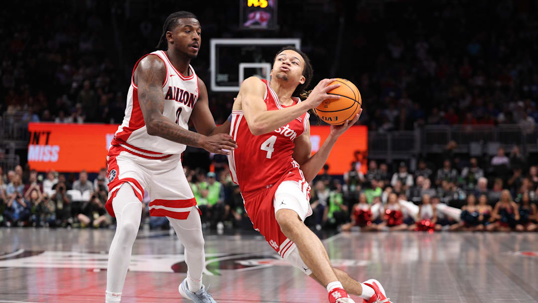 Mar 14, 2026; Kansas City, MO, USA; Houston Cougars guard Kingston Flemings (4) drives to the hoop past Arizona Wildcats guard Jaden Bradley (0) during the second half during the men's Big 12 Conference Tournament Championship at T-Mobile Center. Mandatory Credit: William Purnell-Imagn Images