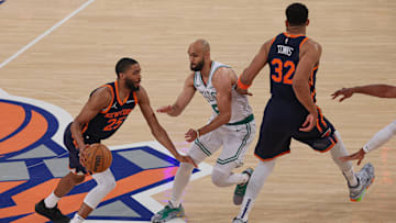 May 12, 2025; New York, New York, USA; New York Knicks forward Mikal Bridges (25) dribbles as Boston Celtics guard Derrick White (9) fights through a screen by New York Knicks center Karl-Anthony Towns (32) in the first half during game four of the second round for the 2025 NBA Playoffs at Madison Square Garden. Mandatory Credit: Vincent Carchietta-Imagn Images