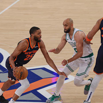 May 12, 2025; New York, New York, USA; New York Knicks forward Mikal Bridges (25) dribbles as Boston Celtics guard Derrick White (9) fights through a screen by New York Knicks center Karl-Anthony Towns (32) in the first half during game four of the second round for the 2025 NBA Playoffs at Madison Square Garden. Mandatory Credit: Vincent Carchietta-Imagn Images