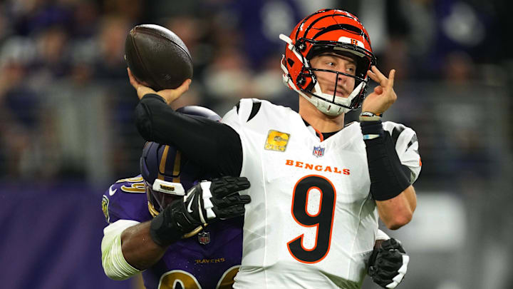 Cincinnati Bengals quarterback Joe Burrow is pressured by Baltimore Ravens linebacker Odafe Oweh.