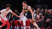 Mar 19, 2023; Brooklyn, New York, USA; Denver Nuggets forward Michael Porter Jr. (1) dribbles against Brooklyn Nets forward Cameron Johnson (2) during the second half at Barclays Center. Mandatory Credit: Vincent Carchietta-Imagn Images