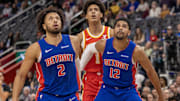 Nov 8, 2024; Detroit, Michigan, USA; Detroit Pistons guard Cade Cunningham (2) and forward Tobias Harris (12) block out Atlanta Hawks forward Jalen Johnson (1) during the first half at Little Caesars Arena. Mandatory Credit: David Reginek-Imagn Images