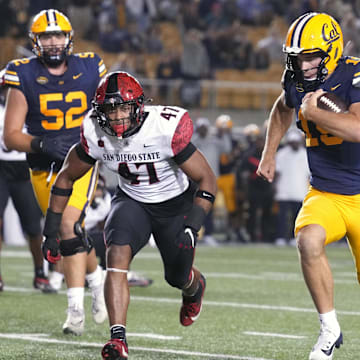 Fernando Mendoza dashes toward the end zone.