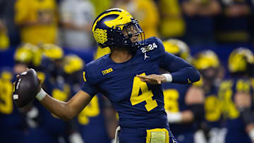 Jan 8, 2024; Houston, TX, USA; Michigan Wolverines quarterback Jayden Denegal (4) against the Washington Huskies during the 2024 College Football Playoff National Championship game.