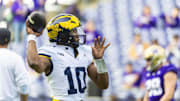 Former Michigan Wolverines quarterback Alex Orji (10) throws during pregame warmups against the Washington Huskies at Alaska Airlines Field at Husky Stadium. 