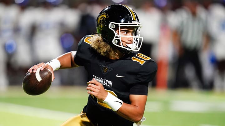 Oct 20, 2023; Carrollton, GA, USA; Carrollton Trojans quarterback Julian Lewis (10) scrambles out of the pocket against the Westlake Lions during the first half at Grisham Stadium. The 15-year-old Carrollton High student has already committed to playing for the University of Southern California Trojans and has been considered one of the top high school quarterback prospects. Mandatory Credit: John David Mercer-USA TODAY Sports