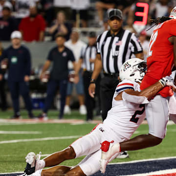 Aug 31, 2024; Tucson, Arizona, USA;  Arizona Wildcats defensive back Treydan Stokes (2) fails to tackle New Mexico Lobos wide receiver Caleb Medford (12) as he makes a touchdown during second quarter at Arizona Stadium.