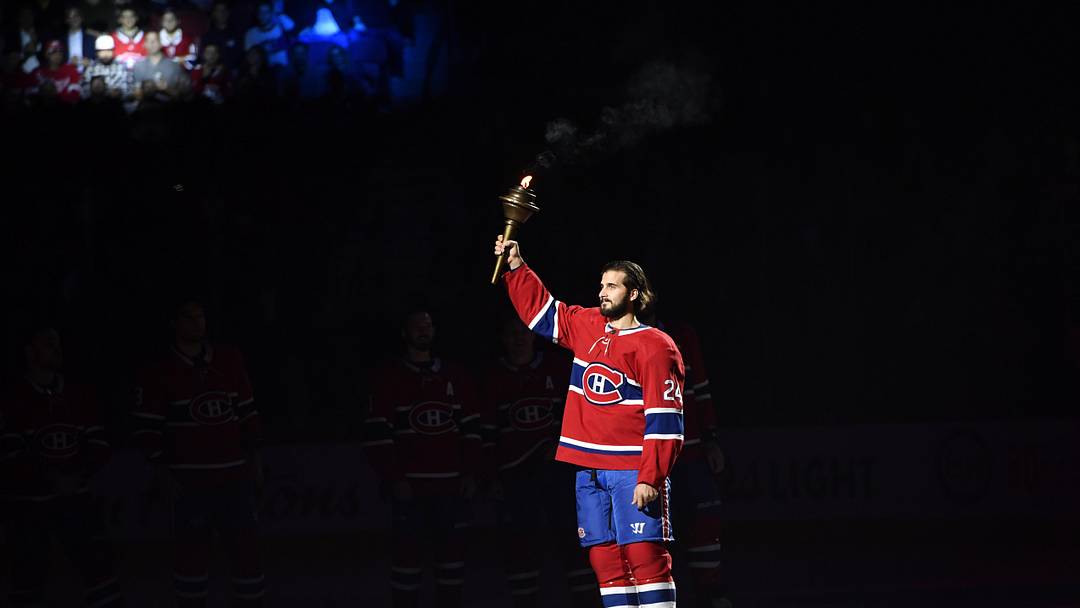 Oct 10, 2019; Montreal, Quebec, CAN; Montreal Canadiens forward Phillip Danault (24) holds the torch during the player introductions before the game against the Detroit Red Wings at the Bell Centre. Mandatory Credit: Eric Bolte-Imagn Images
